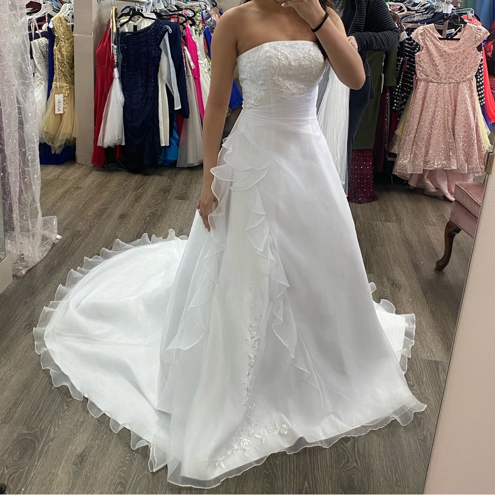 This wedding dress has never been worn- brand new!! It is so beautiful!